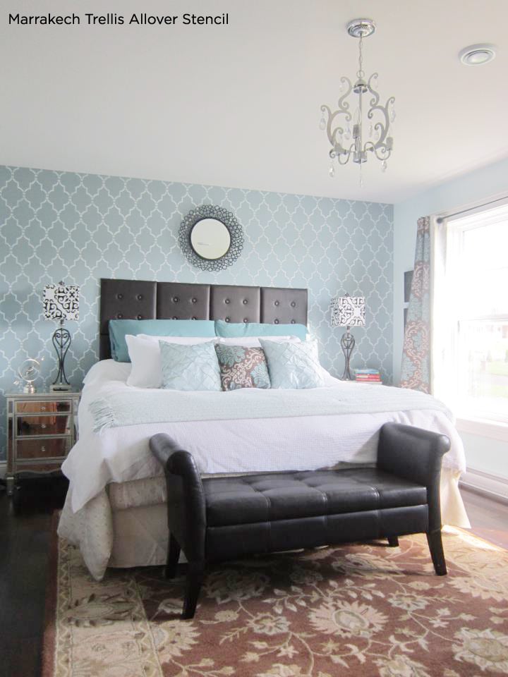 Stunning blue bedroom has an accent wall using the Marrakech Trellis wall stencil from Cutting Edge Stencils.