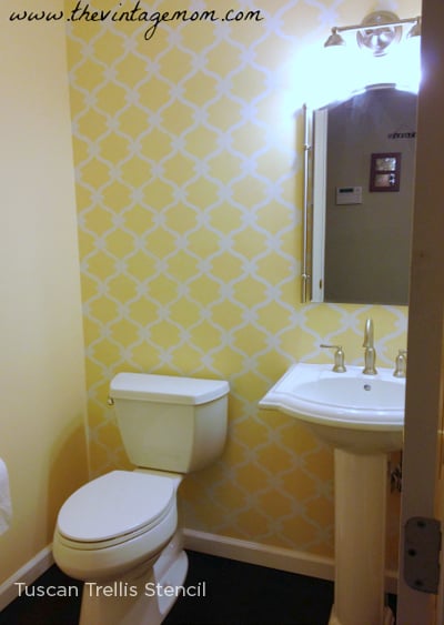 A yellow Tuscan Trellis stenciled accent wall in a bathroom. http://www.cuttingedgestencils.com/tuscan-trellis-allover-stencil.html