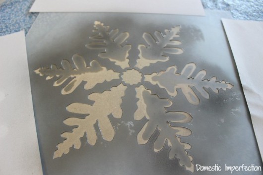 Stenciling a snowflake on glass for a winter craft. http://www.cuttingedgestencils.com/snowflake-stencils.html