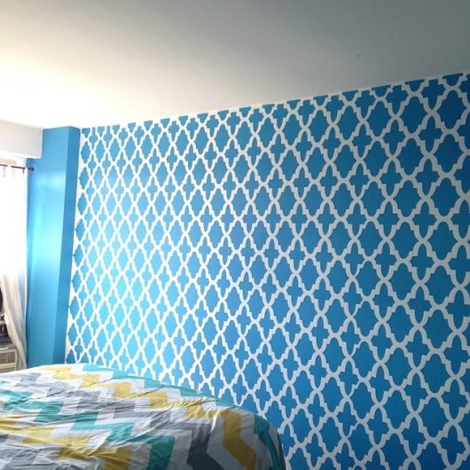 A blue stenciled bedroom accent wall using Hacienda Allover Stencil. http://www.cuttingedgestencils.com/hacienda-stencil-pattern-allover.html