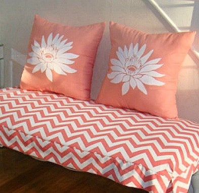 A DIY coral stenciled accent pillow using the Lotus Grande Flower Stencil. http://www.cuttingedgestencils.com/lotus-flower-stencil.html