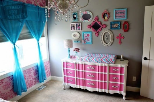 A pink and teal nursery with a Gabrielle Damask stenciled accent wall. http://www.cuttingedgestencils.com/damask-stencil-3.html