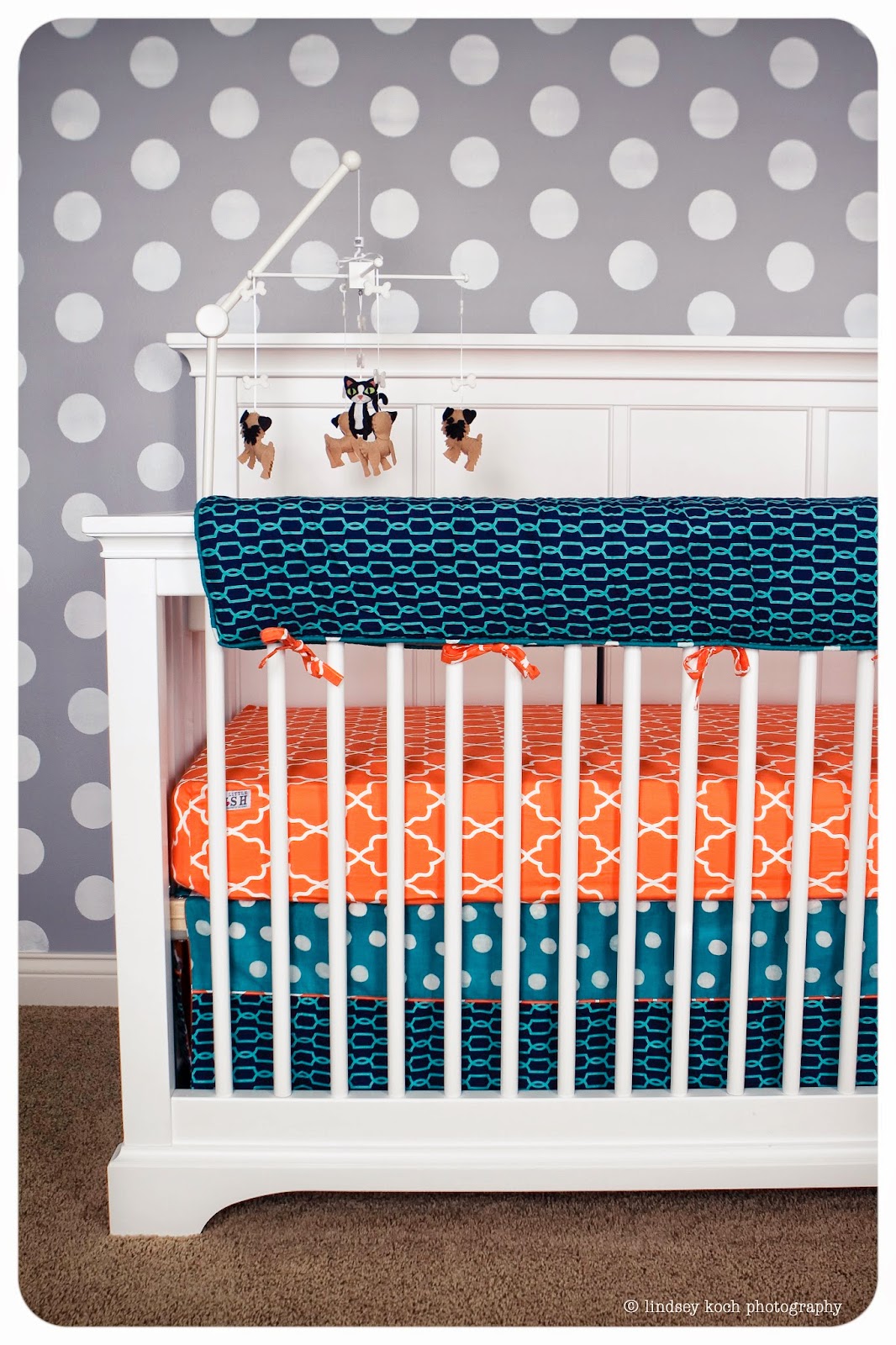 A stenciled nursery in gray with aqua and orange with a Polka Dot stenciled accent wall from Cutting Edge Stencils. http://www.cuttingedgestencils.com/polka-dots-stencils-nursery.html