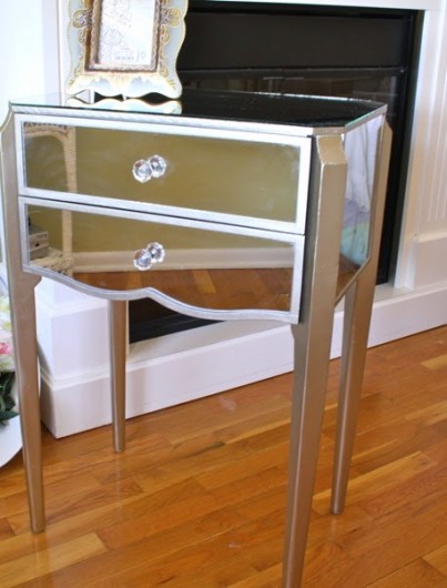 A mirrored side table in a Hollywood Glam bedroom makeover.