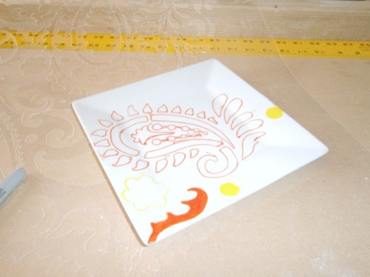Stenciling a DIY stenciled plate idea using the Paisley Allover pattern and sharpies. http://www.cuttingedgestencils.com/paisley-allover-stencil.html