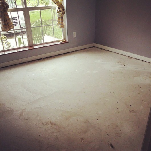 A cement floor in a craft room before the makeover.