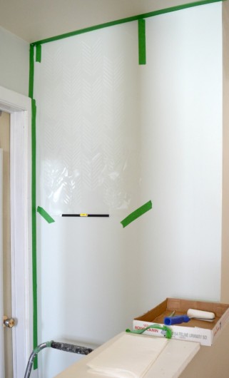 Stenciling the Drifting Arrows Allover stencil in a white hallway. http://www.cuttingedgestencils.com/drifting-arrows-stencil-pattern-diy-decor.html