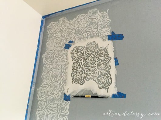 Painting a DIY kitchen accent wall using the Roses Allover Stencil in gray. http://www.cuttingedgestencils.com/roses-stencil-pattern-rose-design.html