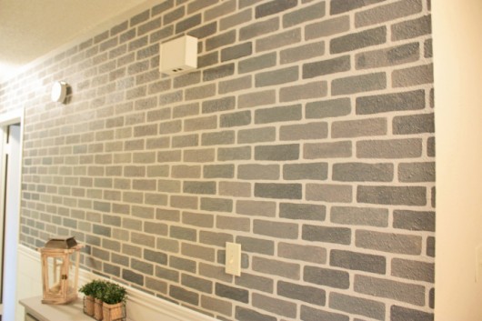 A DIY stenciled accent wall using the Brick Allover Stencil pattern in gray. http://www.cuttingedgestencils.com/bricks-stencil-allover-pattern-stencils.html