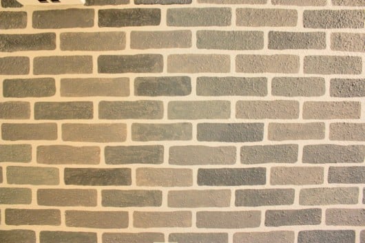 A DIY stenciled accent wall using the Brick Allover Stencil pattern in gray. http://www.cuttingedgestencils.com/bricks-stencil-allover-pattern-stencils.html