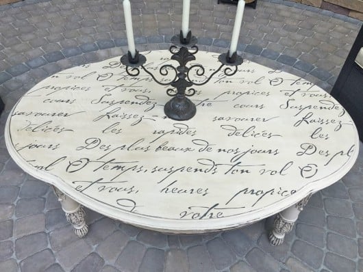 A DIY stenciled outdoor table using the French Poem Allover Stencil. http://www.cuttingedgestencils.com/french-poem-typography-letter-stencil.html