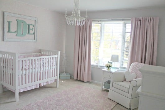 A DIY stenciled accent wall in a nursery using the Roses Allover Stencil in light pink and white. http://www.cuttingedgestencils.com/roses-stencil-pattern-rose-design.html