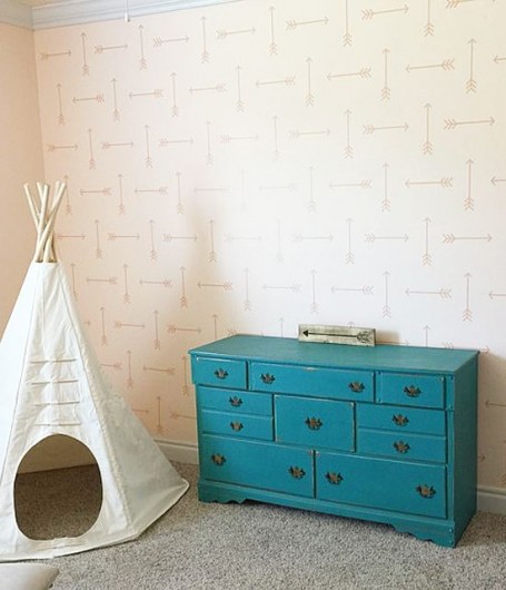 A DIY stenciled accent wall in a nursery using a Tribal Arrows Allover pattern. http://www.cuttingedgestencils.com/tribal-arrow-pattern-stencils-wall-decor.html