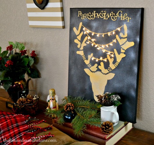 DIY stenciled wall art with lights using the Reindeer Craft Stencil from Cutting Edge Stencils. http://www.cuttingedgestencils.com/reindeer-holiday-stencil-designs-for-diy-crafts.html