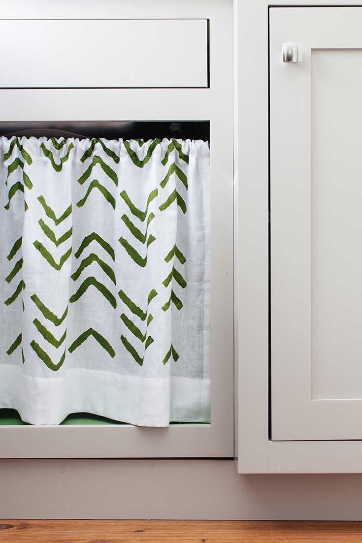 A DIY stenciled laundry room under the sink curtain using the Kuba Chevron Stencil in green from Cutting Edge Stencils. http://www.cuttingedgestencils.com/kuba-chevron-stencil-kim-myles.html