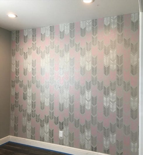 A DIY stenciled accent wall in a playroom using the Drifting Arrows Allover Stencil from Cutting Edge Stencils. http://www.cuttingedgestencils.com/drifting-arrows-stencil-pattern-diy-decor.html 