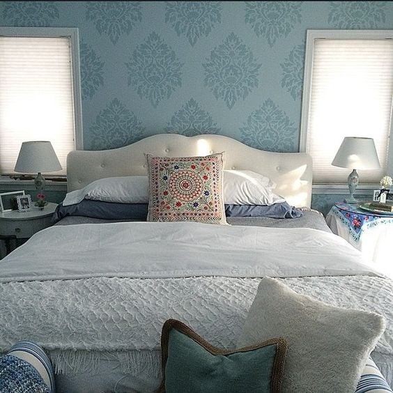 A DIY blue stenciled bedroom accent wall using the Nadya Damask Stencil from Cutting Edge Stencils. http://www.cuttingedgestencils.com/damask-moroccan-stencil.html