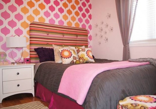 A DIY orange and pink ombre style stenciled accent wall in a girl's bedroom using the Cascade Allover Stencil from Cutting Edge Stencils. http://www.cuttingedgestencils.com/cascade-allover-stencil-pattern.html