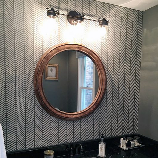 A DIY stenciled bathroom accent wall achieves a wallpaper look using the Herringbone Stitch Allover Stencil from Cutting Edge Stencils. http://www.cuttingedgestencils.com/herringbone-stitch-allover-pattern-wall-stencil.html