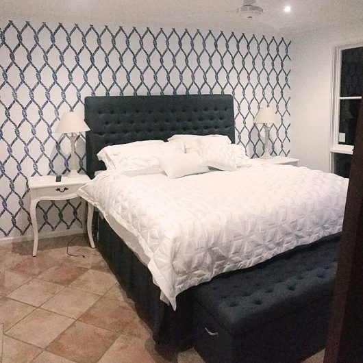 A DIY stenciled bedroom accent wall using the Perfect Catch Allover Stencil from Cutting Edge Stencils. http://www.cuttingedgestencils.com/perfect-catch-stencil-beach-decor.html