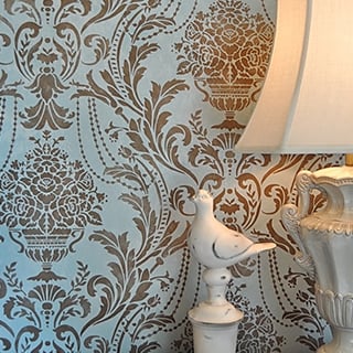 Damask stencil on a blue wall