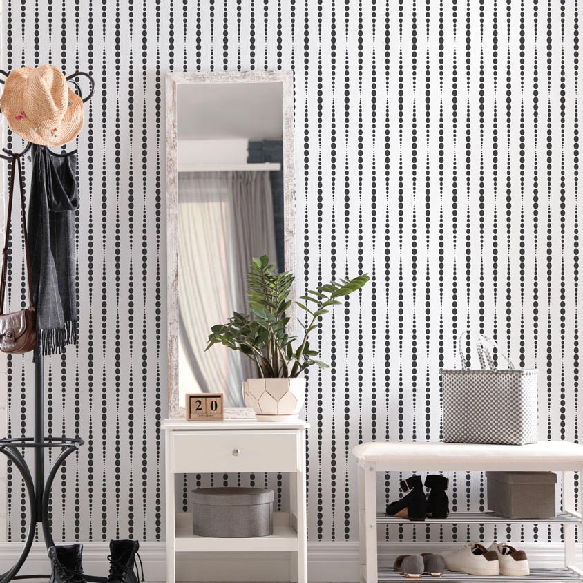 White wall stenciled in black stencil pattern