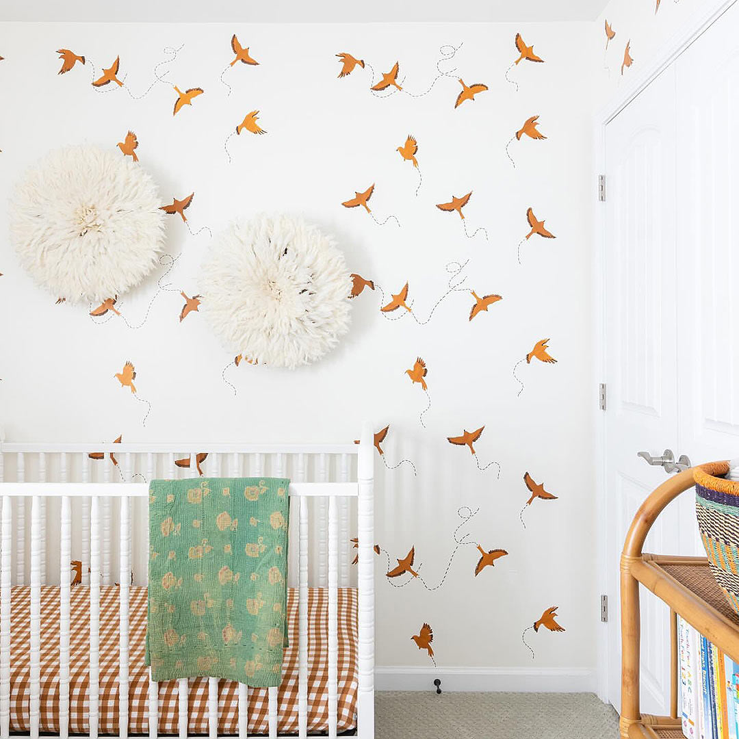 Birds stenciled on a wall in a nursery