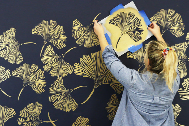 golden chinese ginkgo stencils on a navy blue wall