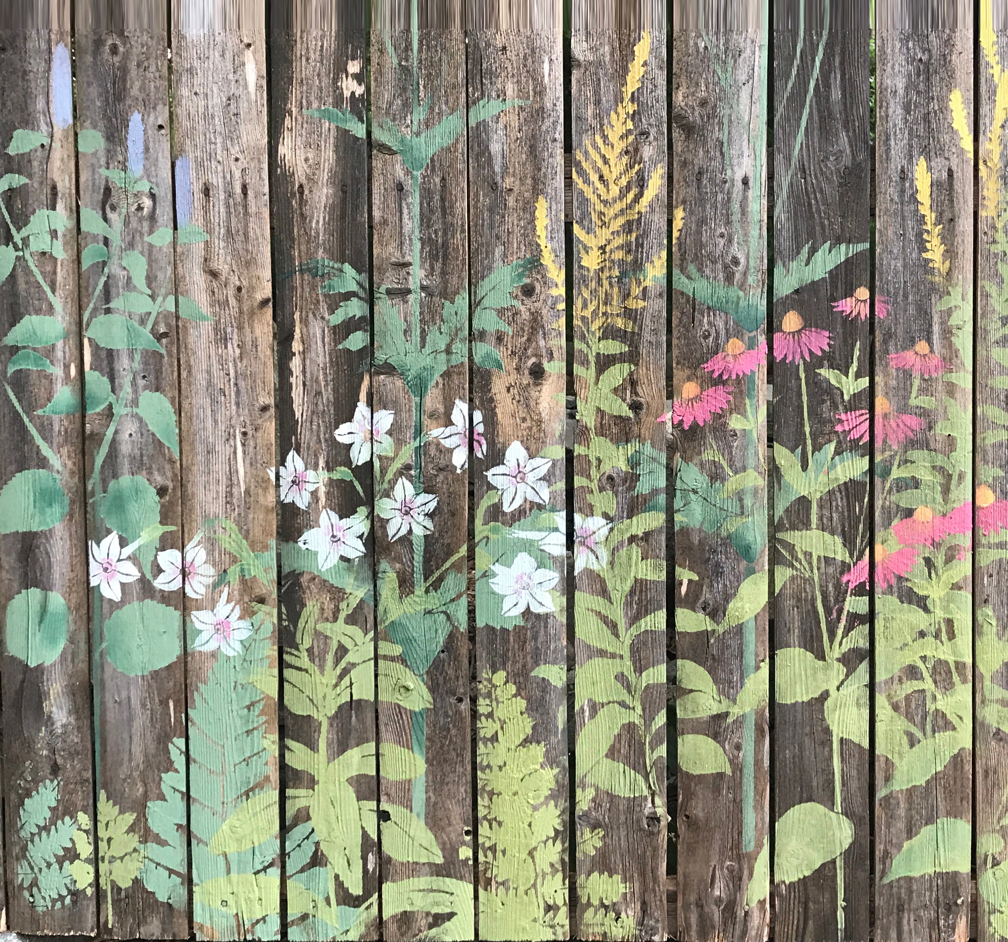 Large floral mural painted on the wooden fence