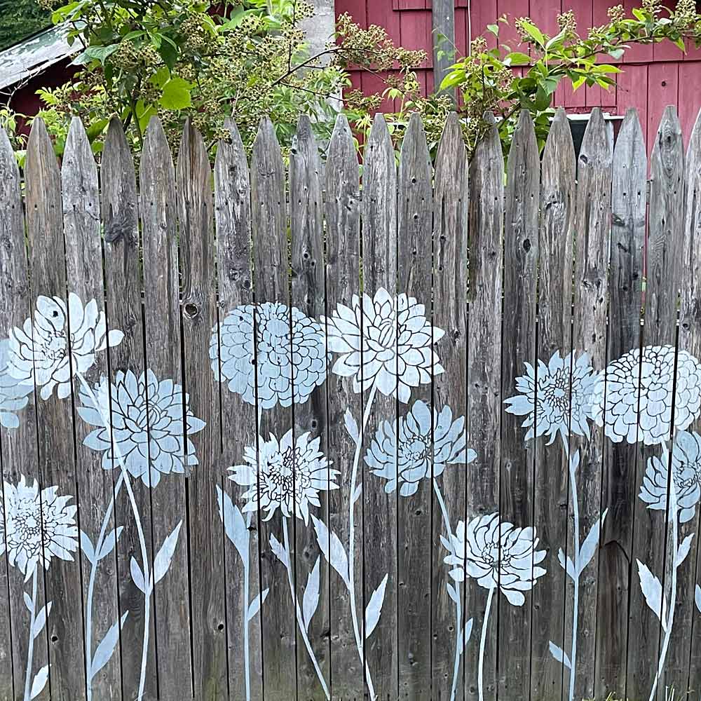 stenciled fence with large flower stencils