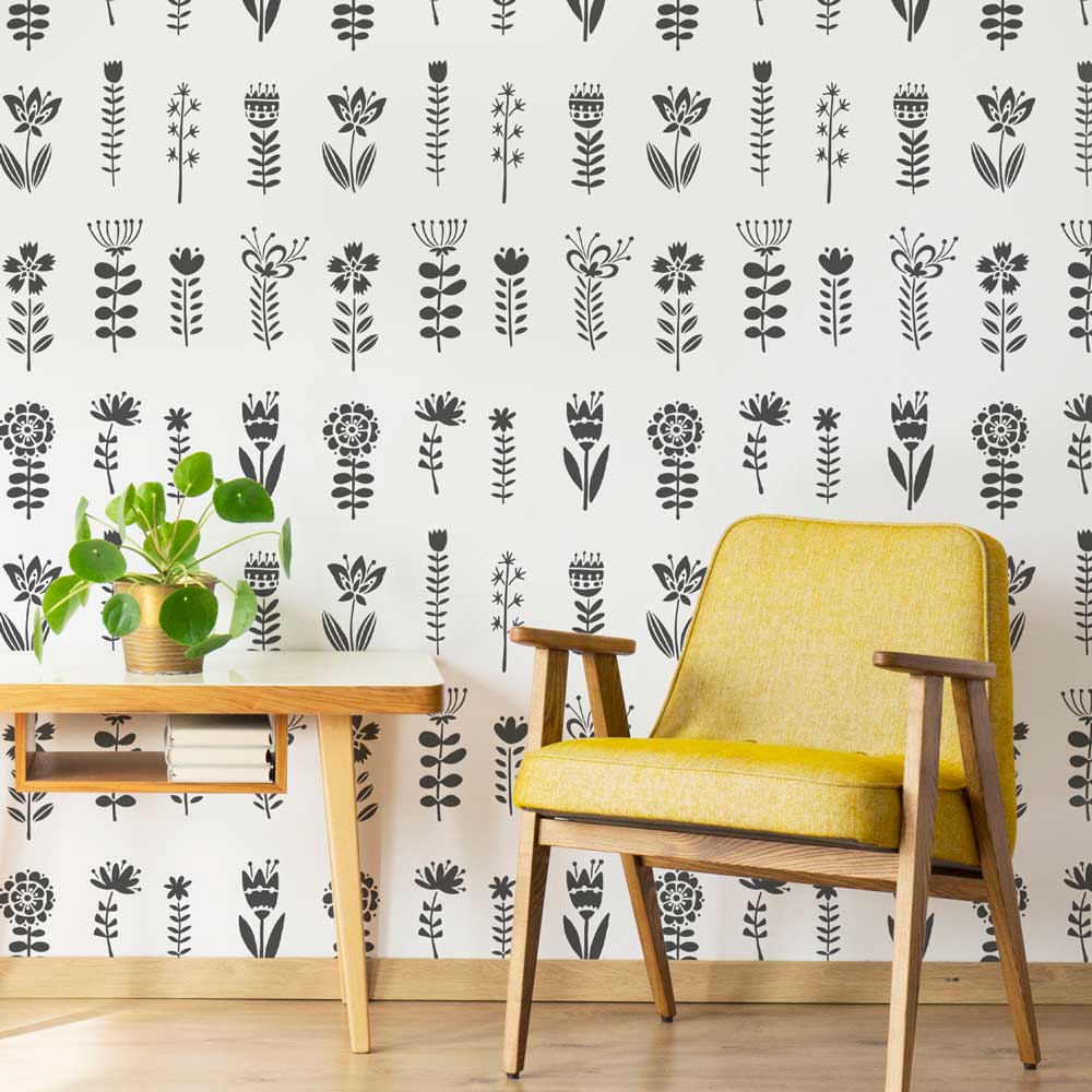 black and white walls yellow chair plants living room wood desk folk flowers allover wall stencil