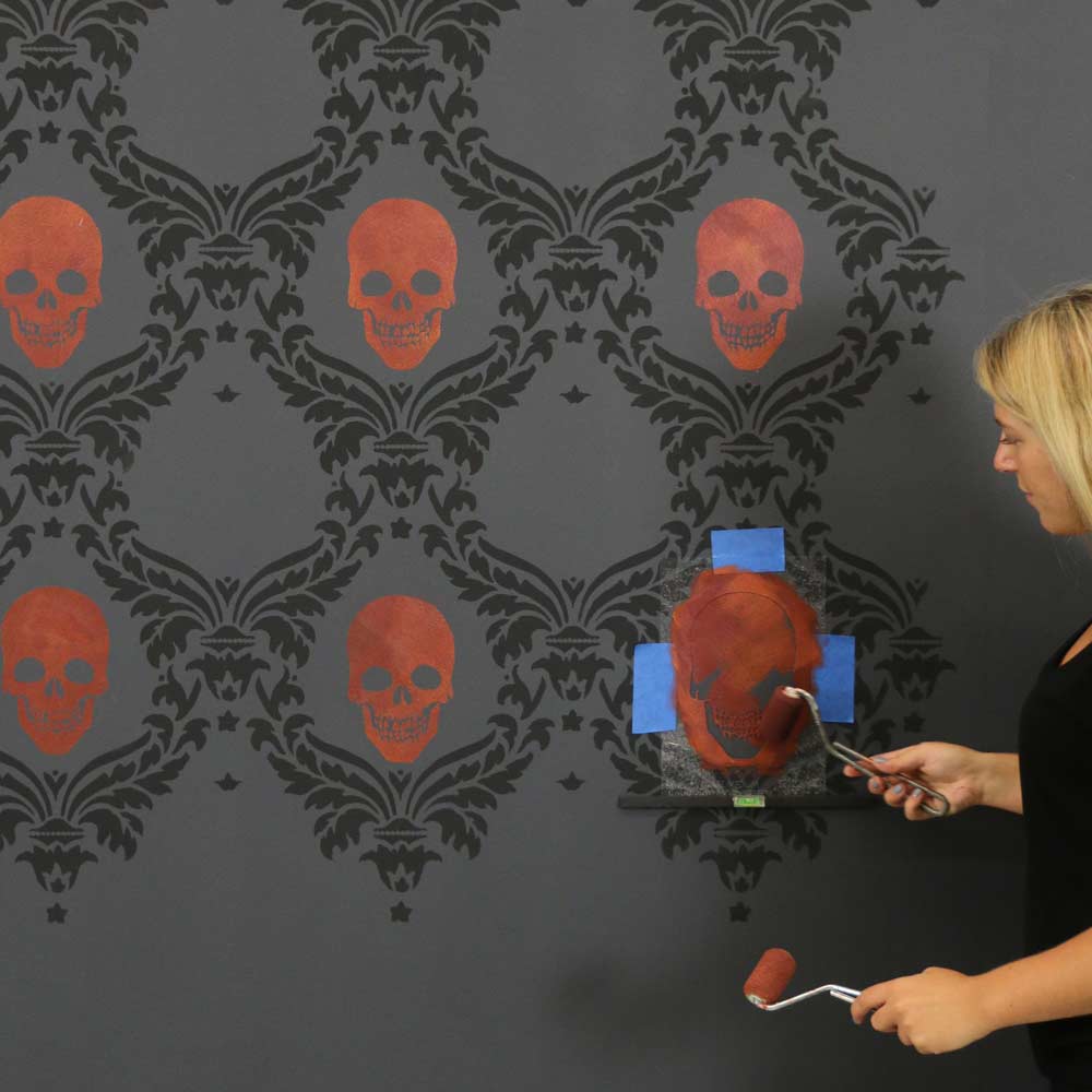 skull halloween craft stencil painted on gray wall