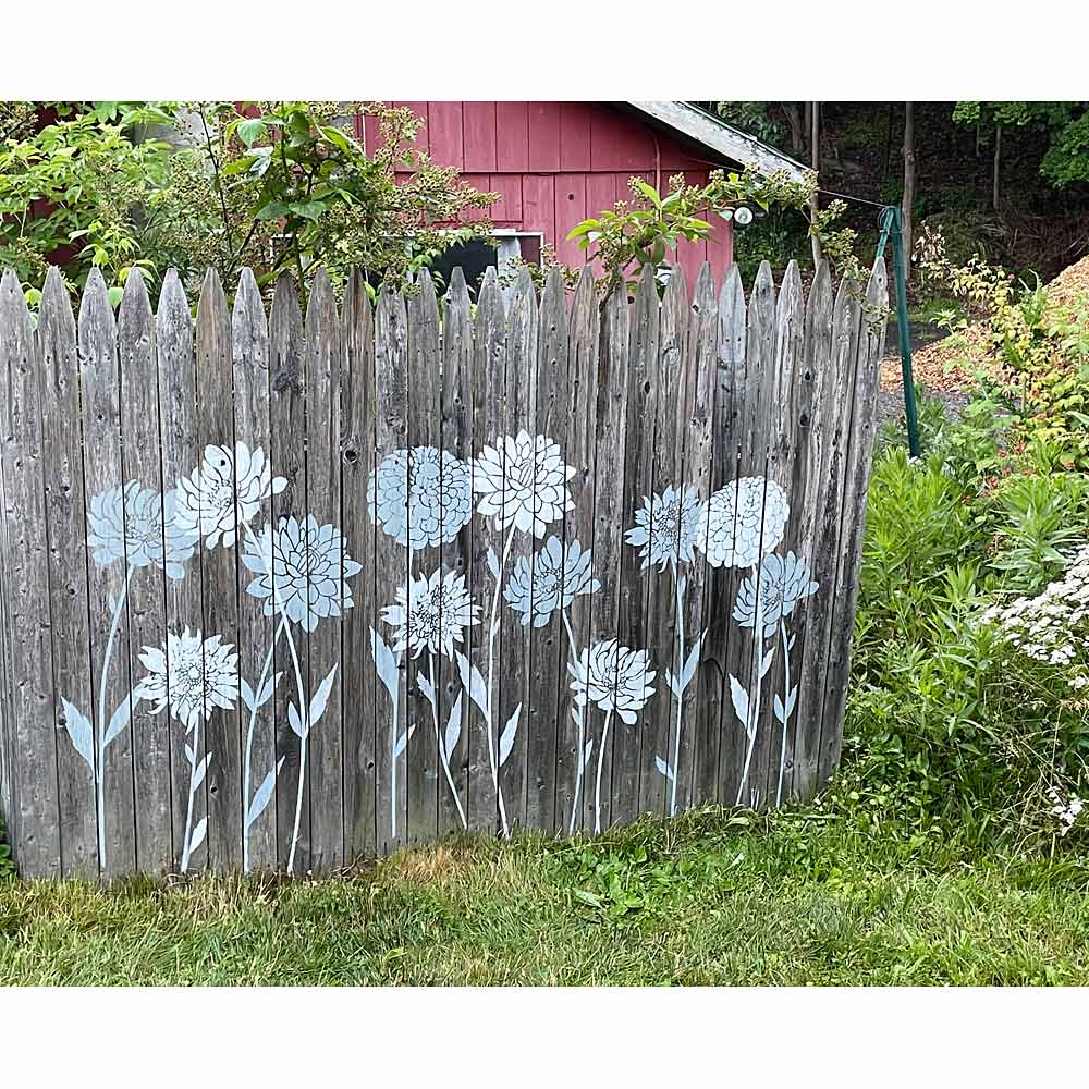 painted fence with flower stencils