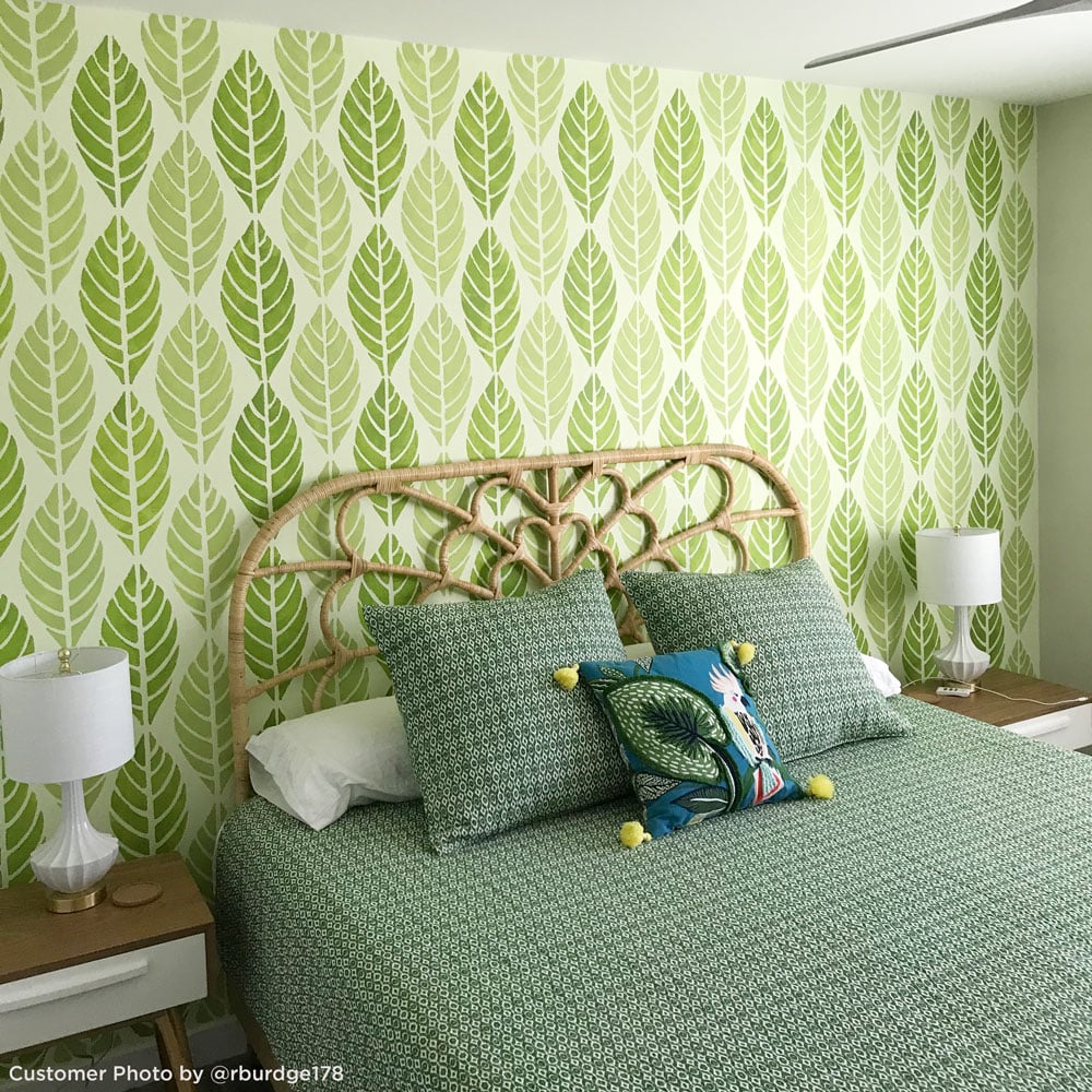 tropical leaves stenciled bedroom wall