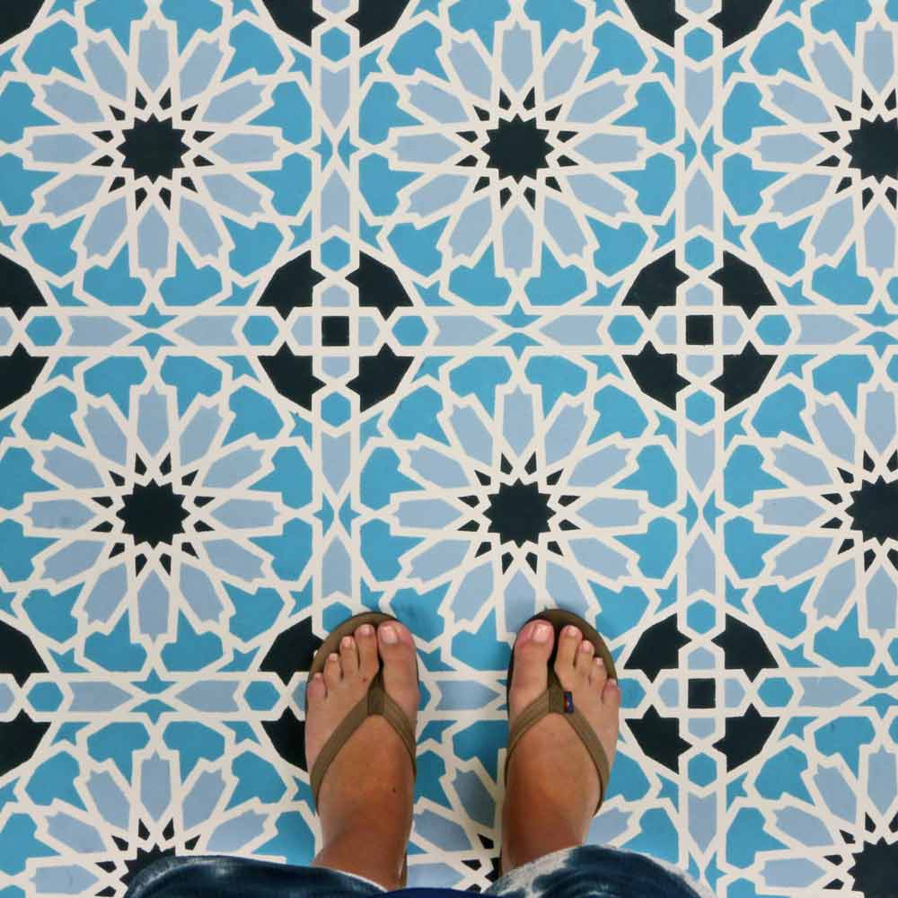 moroccan magic tile stencil in multiple colors on floor with feet