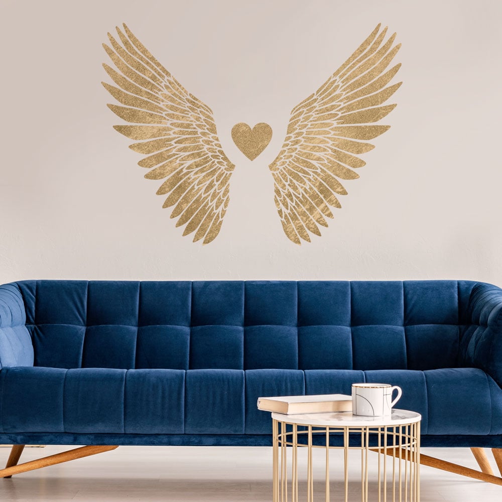 gold wings stencil on living room blue couch