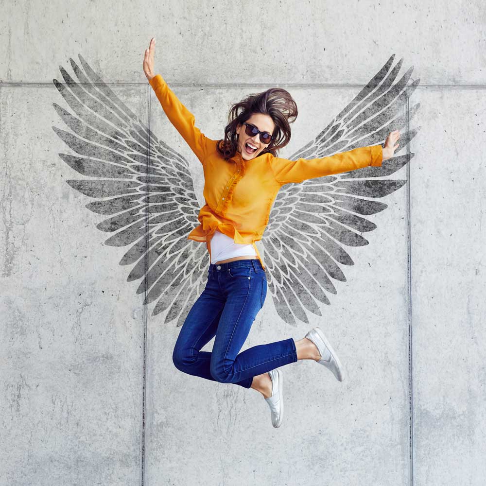 angel wings stencil cement wall girl jumping